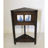 A corner table with inset Delft tiles and lift up top