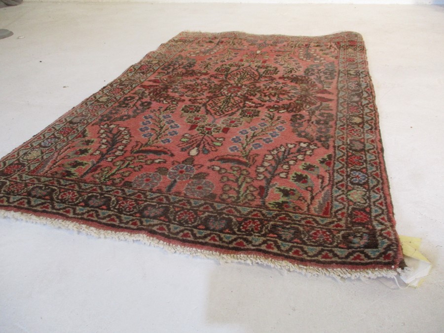 A Persian red ground rug - overall size 110cm x 70cm - Image 3 of 8