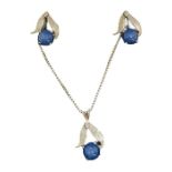 A 14ct white gold ( tested) set of earrings and pendant set with diamonds and star sapphires on a