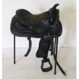 A black leather western saddle plus stirrups with synthetic seat and girth.