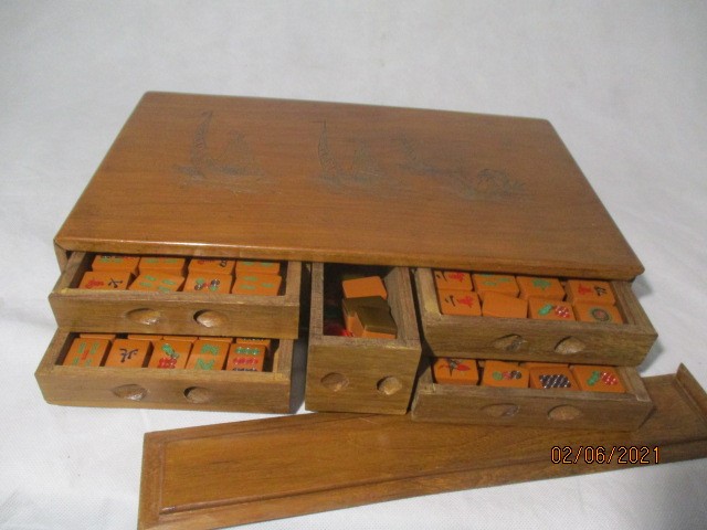 A vintage Mah-jong set in wooden case with incised decoration of junks on a river