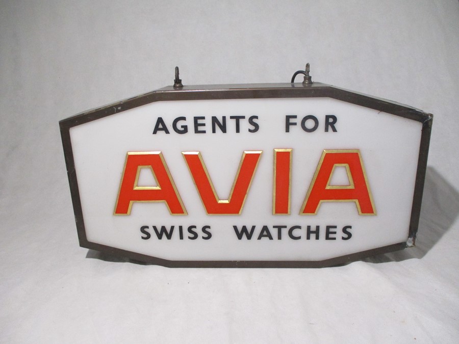 An Avia Swiss Watches light-up shop advertising sign