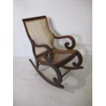 A cane seated rocking chair