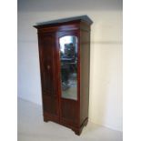 An Edwardian inlaid wardrobe with mirrored door