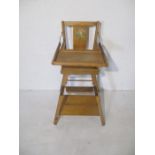 A vintage wooden metamorphic child's high chair
