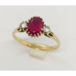 A ruby and CZ three stone ring