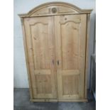 A continental pine two door wardrobe