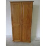 A pine two door wardrobe
