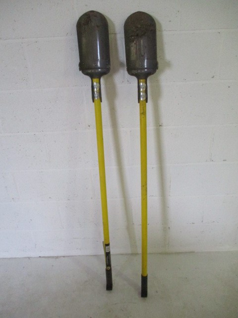 A pair of Roughneck post hole diggers