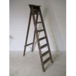 A vintage set of wooden step ladders.