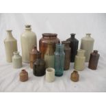 A collection of various stoneware and glass bottles