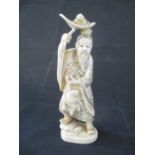 A 19th Century Japanese ivory Okimono of a man holding a lily pad over his head with a toad resting,