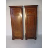 A pair of mahogany wardrobes with one drawer under