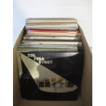 A large collection of 12" vinyl records including Queen, David Bowie, Rolling Stones, The Eagles,
