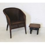 A Lloyd Loom chair with brass feet marked Feb 34 along with a small vintage stool