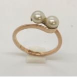 A 9ct rose gold ring set with two pearls