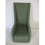 A high backed upholstered arm chair. Height 112cm width 53cm depth 63cm.
