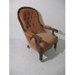 A Victorian button back upholstered chair with mahogany frame