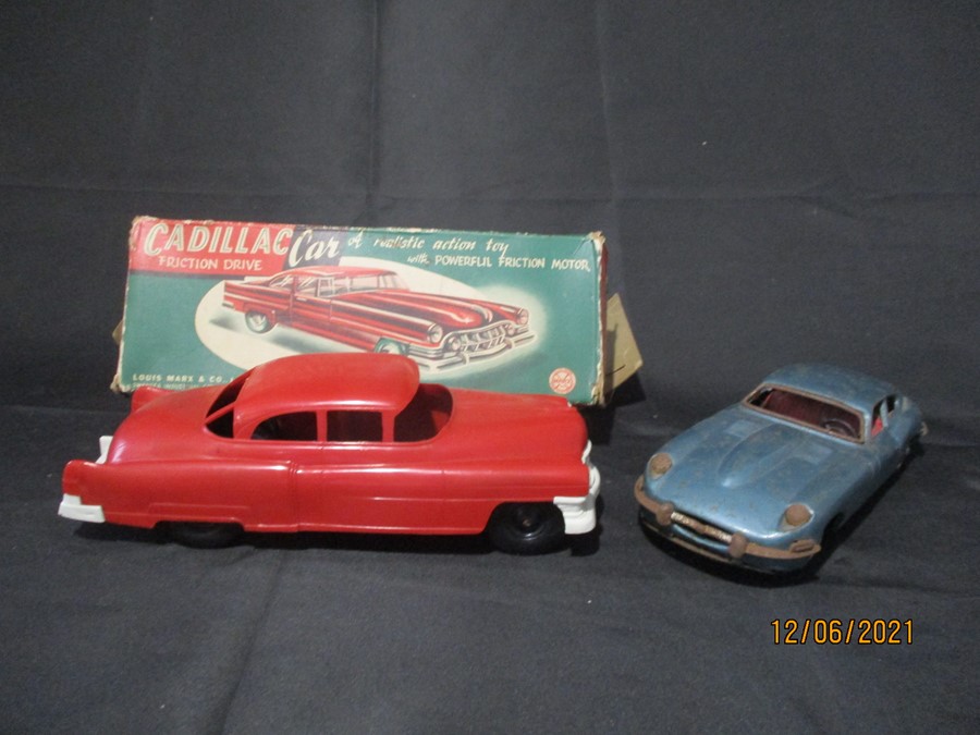 A tin plate friction driven Jaguar XK-E made in Japan and a boxed Marx Toys friction motor plastic