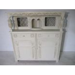 A white painted court cupboard.