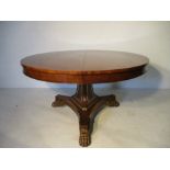 A reproduction centre table with empire style claw feet - diameter 138cm