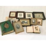 A collection of framed vintage photographs along with two Victorian photo albums