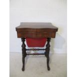 A Victorian walnut veneer games table with single drawer and tapered sewing accessory drawer.
