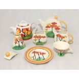 A collection of Past Times china in the style of Clarice Cliff including a teapot, milk jug etc.
