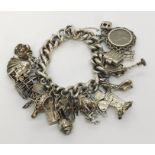 A hallmarked silver charm bracelet with a good quantity of charms, 128.4g