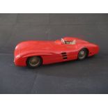 A vintage Mercedes tin plate wind up open wheel racer model car, made in Western Germany.