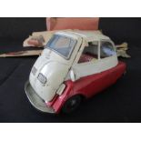 A vintage boxed tin plate friction driven Isetta. Box in poor condition