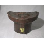 A leather hat box with hat enclosed