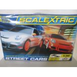 A boxed Scalextric "Street Cars" set with two Porsche 997 GT3 RS, one orange, one silver