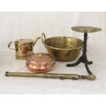 A small collection of brassware and copper including a watering can (handle missing), brass garden