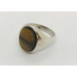 A silver men's signet ring with tiger eye