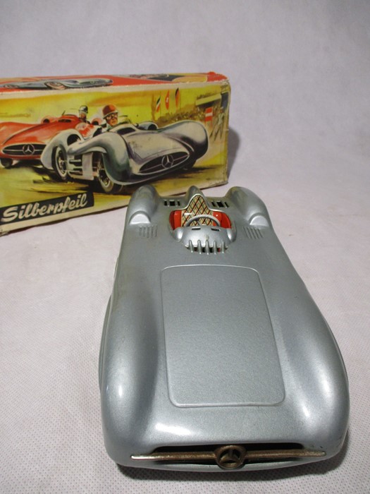 A Silberpfeil Mercedes Silver-Arrow tin plate friction driven open wheel racer model car, No 77,