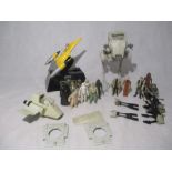 A collection of Star Wars memorabilia including Imperial Speeders and All Terrain Scout Transport (