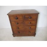 A Victorian mahogany chest of five drawers on wheels