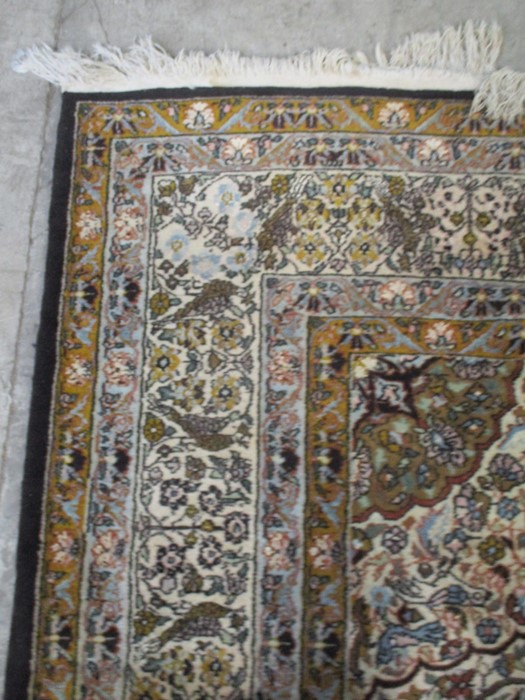 A black ground carpet with floral design, animals etc. approx 12ft x 8ft 10 inches - Image 6 of 8