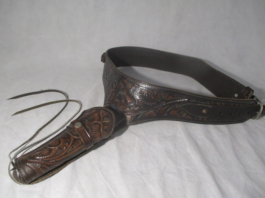 A tooled leather holster and belt