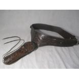 A tooled leather holster and belt