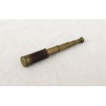 A small brass five draw telescope with wooden grip