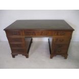 A reproduction kneehole desk - height 77cm, width 137cm, depth 76cm