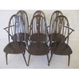 A set of six Ercol stained beechwood Windsor style hoop and stick back dining chairs, with shaped