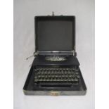 A vintage Corona Standard typewriter in carry case