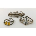 A Charles Horner silver brooch, a Rene Mackintosh inspired brooch and one other all marked as