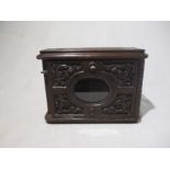 A Victorian carved wooden letter box with drop down front and glazed panel