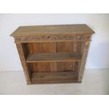 An oak bookcase with carved decoration