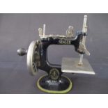 A child's miniature Singer sewing machine