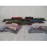 A collection of Atlas model railway locomotives on stands